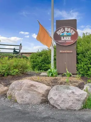 a sign for a dog bay inn with rocks at La Casita at Creekview in Gouldsboro