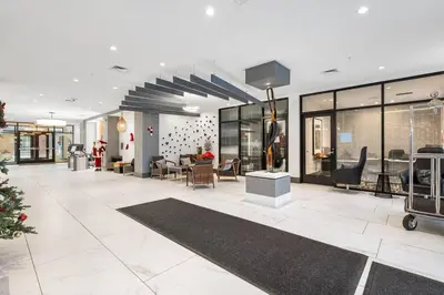 a lobby of a building with chairs and tables at Luxury Living in Jersey City Only Steps Away from Manhattan in Jersey City
