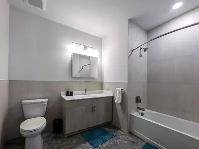 a bathroom with a toilet and a sink and a tub at 324 Brand New 1 Bedroom 1 Bath 1 Kitchen 1 Liv in Dunellen