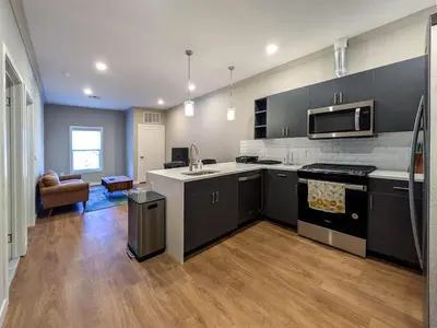 a kitchen with black and white appliances and a living room at 324 Brand New 1 Bedroom 1 Bath 1 Kitchen 1 Liv in Dunellen