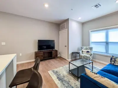 a living room with a blue couch and a tv at 222 Brand New 2 Bedroom 1 KIT 2 BATH 1 Living in Dunellen
