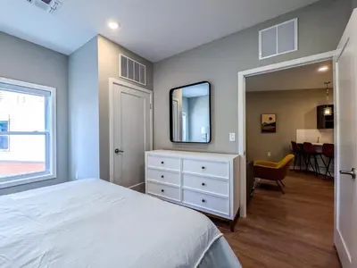 a bedroom with a bed and a dresser with a mirror at 310 Brand New 1 Bedroom 1 Bath 1 Full Kit 1 Liv in Dunellen