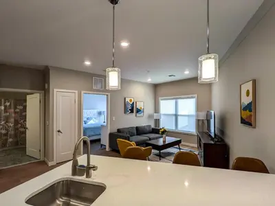 a kitchen and living room with a couch and a table at 310 Brand New 1 Bedroom 1 Bath 1 Full Kit 1 Liv in Dunellen
