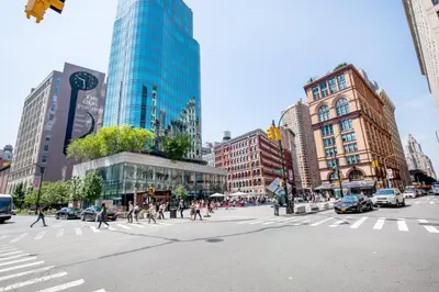 a busy city street with people crossing a crosswalk at E Village 1BR w Doorman Gym nr Union Sq NYC-10 in New York