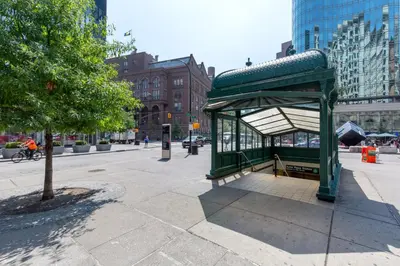 a bus stop on the side of a city street at E Village 1BR w Doorman Gym nr Union Sq NYC-10 in New York