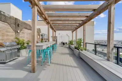 a balcony with tables and chairs on a building at Palatial 1BR with Rooftop Pool in Philadelphia