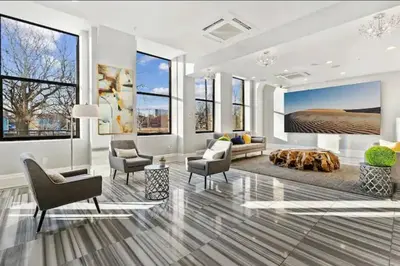 a living room with a couch and chairs and a table at Sleek 1BR with Rooftop Amenities in Philadelphia