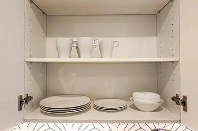 a cupboard with plates and dishes on it at Studio Apartment in the Heart of Philadelphia in Philadelphia