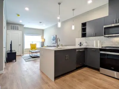 a large kitchen with a sink and a stove at 327 Modern 1BR Apt Walk to NJT in Dunellen