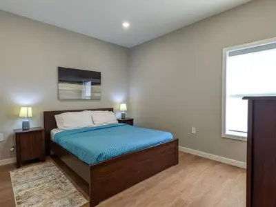 a bedroom with a bed and a large window at 327 Modern 1BR Apt Walk to NJT in Dunellen