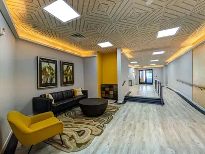 a living room with a couch and a yellow chair at 327 Modern 1BR Apt Walk to NJT in Dunellen