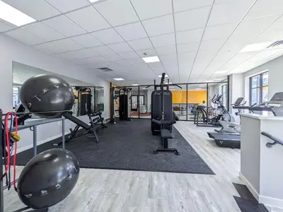 a gym with treadmills and exercise equipment in a room at 227 Modern 1BR Apt Walk to NJT in Dunellen