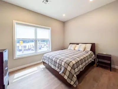 a bedroom with a bed and a window at 328 Modern 2BR Apt in Dunellen