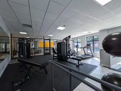 a gym with treadmills and machines in a room at 312 Modern 1BR Apt Walk to NJT in Dunellen