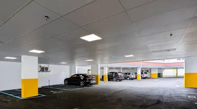 a parking garage with two cars parked in it at 212 Modern 1BR Apt Walk to NJTransit in Dunellen