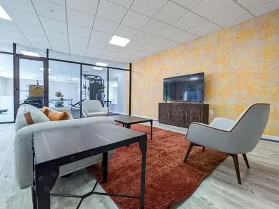 a living room with a couch and a table and a tv at 212 Modern 1BR Apt Walk to NJTransit in Dunellen