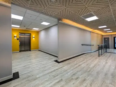 a large room with yellow walls and wooden floors at 329 Modern 1BR Apt Walk to NJT in Dunellen