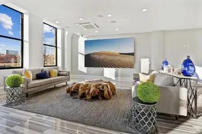 a living room with a couch and a table at High-End 1BR with Rooftop Amenities in Philadelphia
