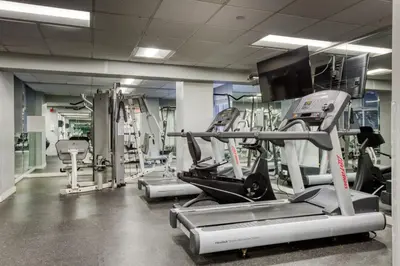 a gym with several machines and a flat screen tv at Blueground Upper West Side ac wd NYC-1546 in New York