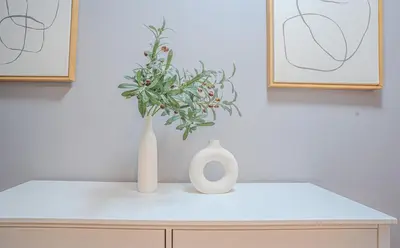 two white vases sitting on top of a table at Stylish 3Bd in Manhattan near the Empire State Building in New York