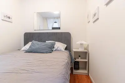 a bedroom with a bed and a mirror on the wall at Charming 3Bd in Manhattan in New York