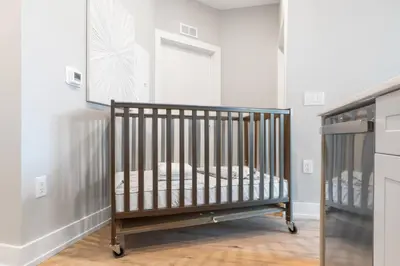 a baby crib in a room with a window at Sleeps 6 - Pier Views - Near Fishtown and Old City in Philadelphia