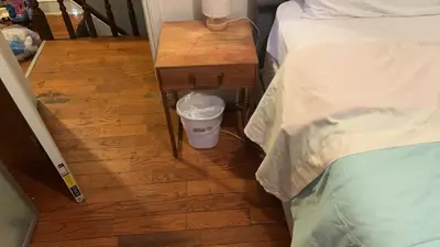 a small table with a trash can next to a bed at 2218 N Colorado Double Rooms in Eldorado