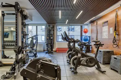 a gym with several treadmills and cardio machines at Blueground Upper West Side nr parks wd NYC-1678 in New York