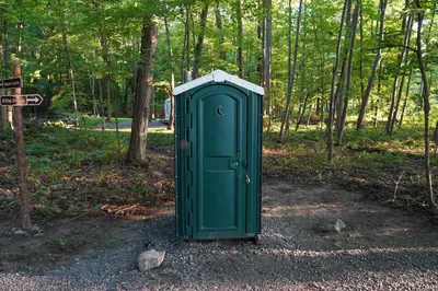 a green box sitting in the middle of a park at Campsite 1 at Moon Valley Campground in Vernon Township
