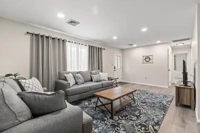 a living room with a couch and a table at Joyful 5 Bedroom Home in Harrisburg