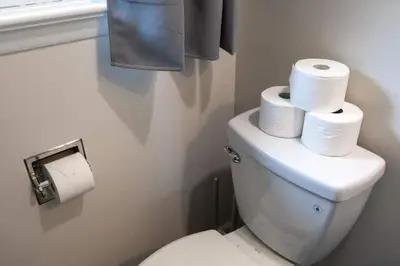 a bathroom with a toilet with three rolls of toilet paper at Joyful 5 Bedroom Home in Harrisburg