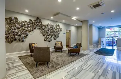 a lobby with chairs and a wall with a balloon at Modern NoLibs Studio - Pool & Gym in Philadelphia