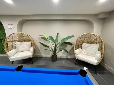 two chairs and a ping pong table in a room at Charming 1BR King Bed - Just 20 Minutes from NYC! in Newark
