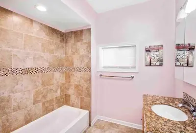 a bathroom with a bath tub and a sink at Modern Cozy Huge Balcony in Heart of Passyunk in Philadelphia