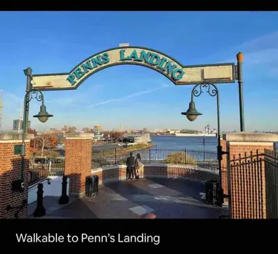 a sign for a pier with two people walking under a street light at New - Suite by Rittenhouse Square in Philadelphia