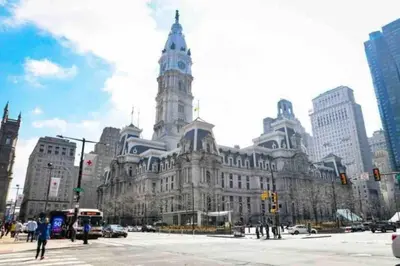 a large building with a clock tower in a city at NEW - 1 Bedroom close by Rittenhouse Square in Philadelphia