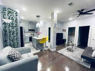 a living room with a couch and a kitchen at Stunning 1Bedroom Apartment in Center City in Philadelphia