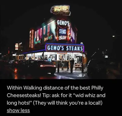 a sign for a restaurant on a city street at night at Lovely 1BD Apt Near Magic Garden in Center City in Philadelphia