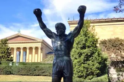 a statue of a man with his arms in the air at Lovely 1BD Apt Near Magic Garden in Center City in Philadelphia