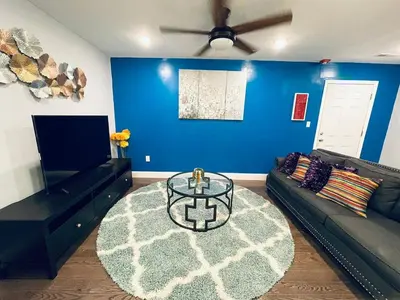 a living room with a couch and a table at Magic Gardens 1BD Apt in Center City in Philadelphia