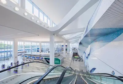 an airport terminal with a escalator in a building at Duplex apt - Dining - 80in Projector - Pool Table in Bayonne