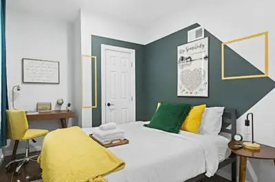 a bedroom with a bed and a desk and a chair at W3S - Large 7br 3bath - Sleeps 20 - 3 Living rooms - Yard and Deck in Bayonne