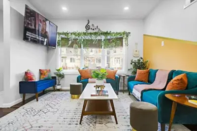 a living room with a blue couch and a table at W3S - Large 7br 3bath - Sleeps 20 - 3 Living rooms - Yard and Deck in Bayonne