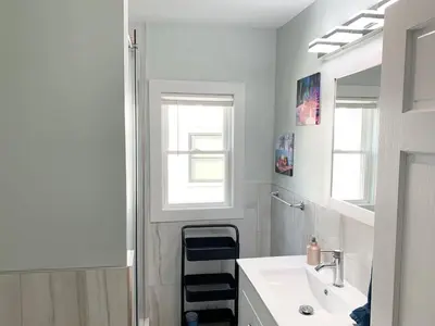 a white bathroom with a sink and a mirror at Lovely 1 BD downtown 2F apt in quite neighborhood in Montclair
