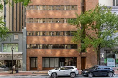 two cars parked in front of a brick building at Beautiful New Apartment I 1 Bedroom 1 Bathroom in Wilmington