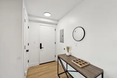 a hallway with a table and a mirror on a wall at Market View Residence in Wilmington