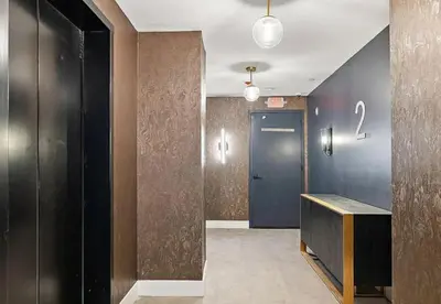 a hallway with a blue door and a number on the wall at Stunning 1bd1bth I New Construction in Wilmington