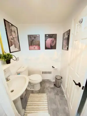 a bathroom with a white toilet and a sink at Entire House in West Ny, NJ12 mints from NYCity Time Square in West New York