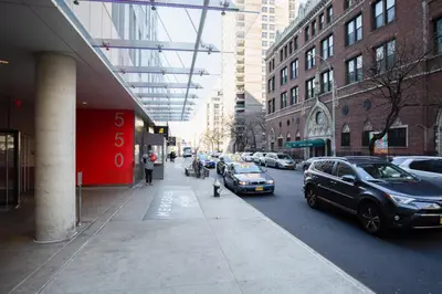 a city street with cars parked on the side of the road at Hells Kitchen 1BR w Doorman nr Central Park NYC-521 in New York