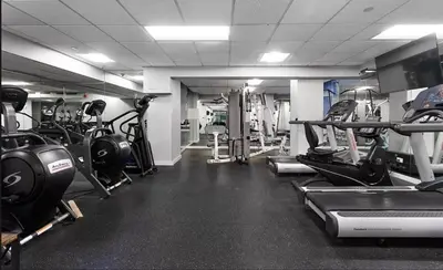 a gym with lots of treadmills and machines at 73-806 New 1BR 1Bth UWS Doorman Gym in New York